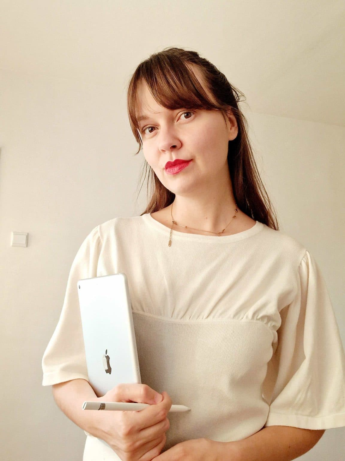 Hana Agic - Interior Designer Hana Agic holding laptop