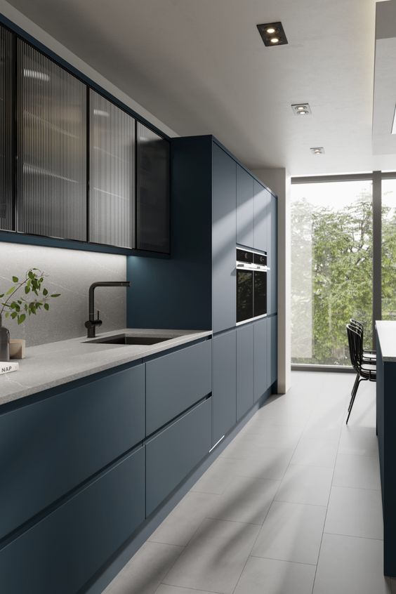 Blue kitchen cabinets with gray flooring