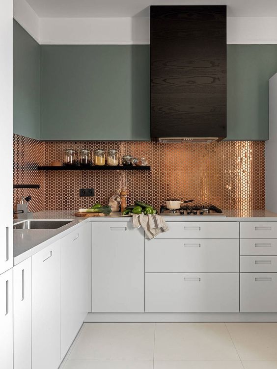 White kitchen countertops and bronze backsplash