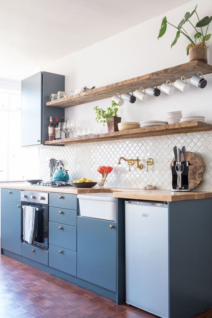 One wall kitchen with blue cabinets and open shelves