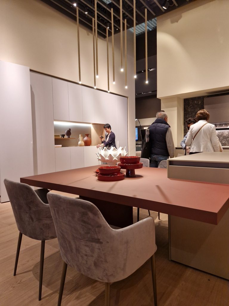 Bright kitchen with solid surfaces, light fixtures and dining room