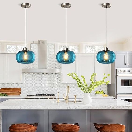 Navy blue statement pendants above kitchen sink